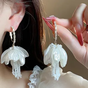 Elegant French floral tassel earrings with sparkling crystals and pearl-like petals.