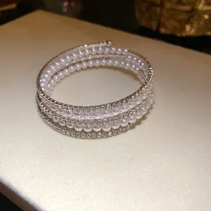 Three-layer open wrap bracelet featuring elegant white pearls and sparkling rhinestones