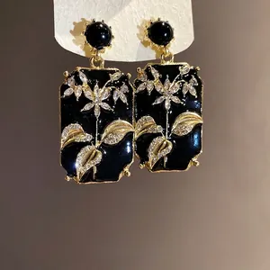 Vintage black enamel rectangular drop earrings with gold floral rhinestone details