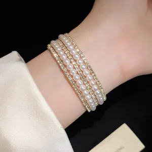 Close-up of multi-layer bracelet with pearls and rhinestones on woman's wrist