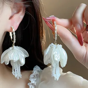 Elegant white petal earrings with pearl tassels and shimmering zircon-encrusted hoops.