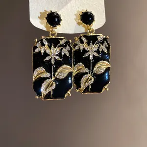 Vintage style black enamel square drop earrings with gold flower and rhinestone details