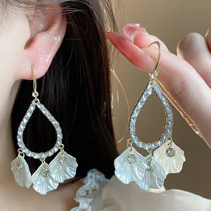 Detailed view of French style crystal petal drop earrings with sparkling stones