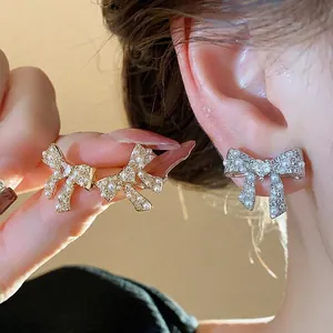 Elegant 18k gold plated bow stud earrings with sparkling pearls and silver needles