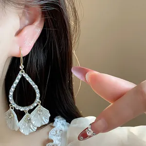 Close-up of elegant French style floral teardrop earrings with sparkling crystals, chic