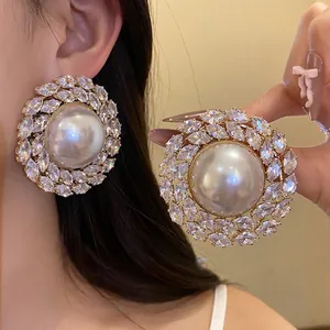 Elegant vintage round pearl stud earrings with a sparkling marquise zircon halo.