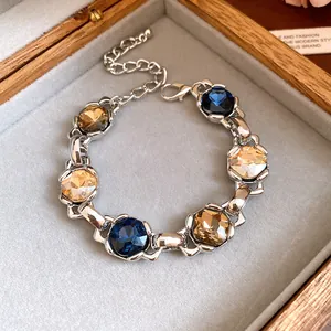 Close-up of vintage silver bracelet with large blue and amber faceted zircon stones