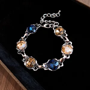 Close-up detail of a vintage rhombus zircon adjustable bracelet with blue and amber stones