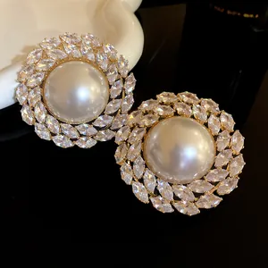 Macro view showing shimmering marquise-cut zircons surrounding a large lustrous pearl.