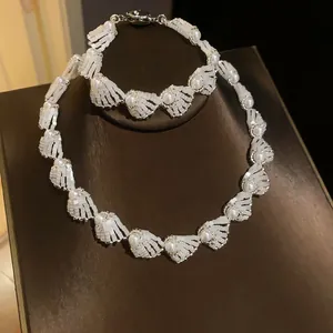 Detailed view of elegant pearl and shell fan-shaped necklace and bracelet jewelry set