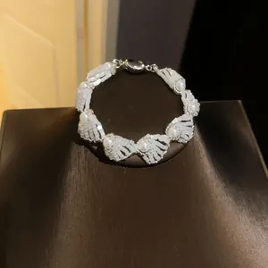 Detailed macro view of an elegant pearl and white bead bracelet for women