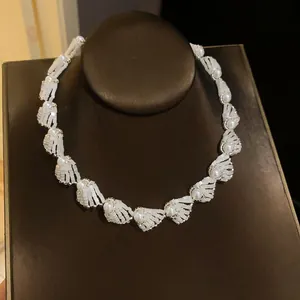 Close-up of elegant white pearl woven necklace on a dark jewelry display stand