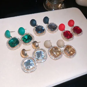 Luxury square geometric crystal drop earrings in five colors on a display board