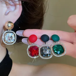 Close-up of luxury rhinestone geometric round earrings available in multiple colors