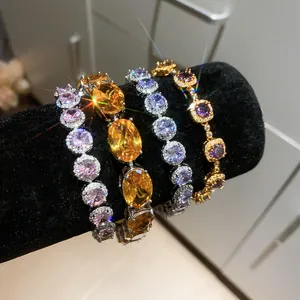 Detail view of sparkling 18k gold plated zircon bracelets with multi-color stones