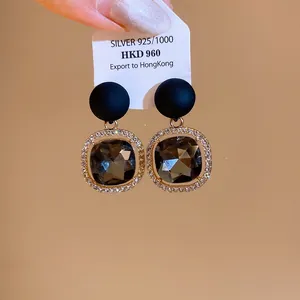 Detailed view of elegant square grey gemstone earrings with sparkling diamond-encrusted borders