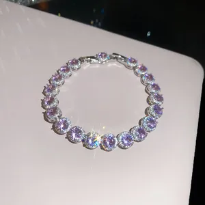 Close-up of 18k gold plated bracelet featuring sparkling purple zircons and halo detail.