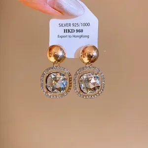 Elegant 925 silver stud earrings featuring round gold beads and large crystal stones