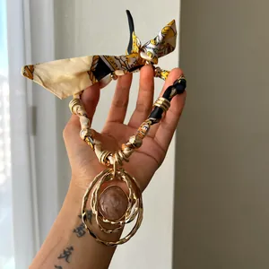 Bohemian resin pendant necklace with silk scarf strap and gold-tone hammered metal rings