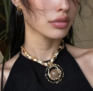 Detailed close-up of a high-end resin pendant necklace on an elegant female model