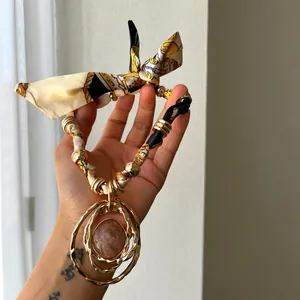 Luxury designer necklace with a layered gold ring pendant and silk scarf fabric chain
