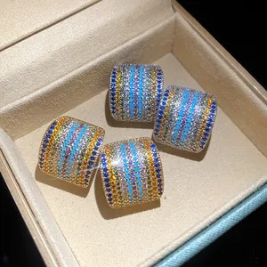 Detailed macro view of vintage square stud earrings set with vibrant colorful cubic zirconia