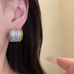 Close-up shot of vintage-style square stud earring featuring rows of multi-colored zircons
