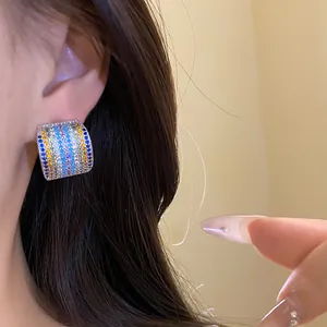 Close-up detail of vintage square earrings pave-set with multi-colored cubic zirconia stones