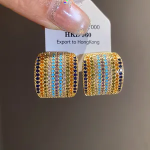 Close-up detail of vintage square stud earrings with rainbow zircon micro-pave