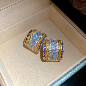 Macro view of vintage-style square stud earrings with colorful pavé cubic zirconia