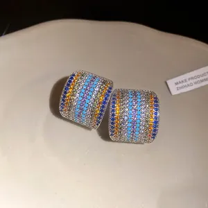 Close-up detail of vintage square stud earrings with rainbow zircon pave setting