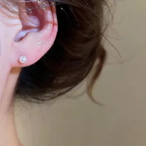 Elegant classic round white pearl stud earring on model for a sweet minimalist look