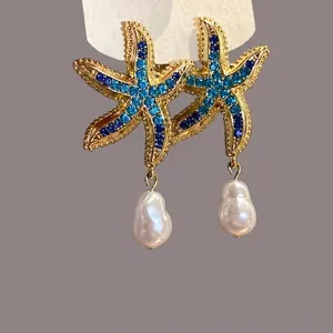 European style gold starfish earrings with blue crystals and dangling baroque pearls