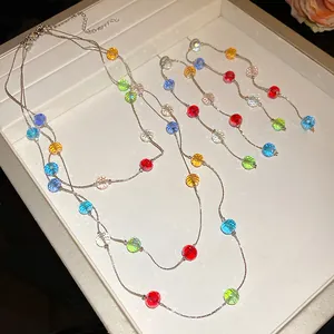 Three-layer necklace and earring set with colorful faceted glass beads on silver chains
