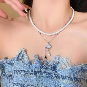 Detailed view of a double-layered necklace featuring a zircon cloud and pearl drop.