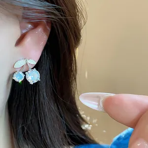 Detailed close-up of elegant cherry stud earrings featuring sparkling cubic zirconia stones