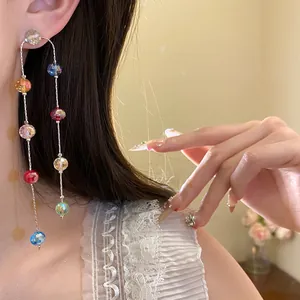 Detail of long colorful faceted glass bead earrings for resort style vacation looks