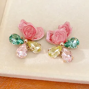 Elegant butterfly stud earrings featuring pink enamel and colorful crystals.