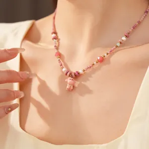 Handmade pink ceramic beaded necklace featuring a cute dog pendant and elegant pearls