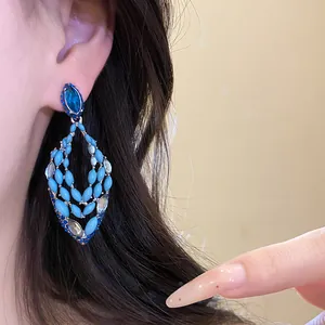 Detail view of blue bohemian teardrop earrings with crystals and enamel beads