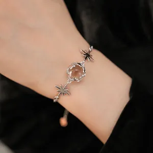 Elegant silver star and round glass bracelet on a feminine wrist