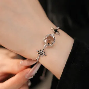 Elegant silver star and glass bead bracelet with zirconia shown on a woman's wrist
