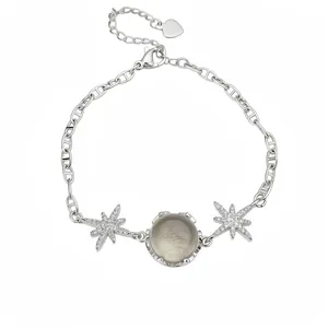 Silver starburst charm bracelet with round grey glass stone and zircon inlays