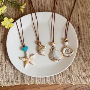 Bohemian summer beach necklaces with starfish and seashell pendants on a plate