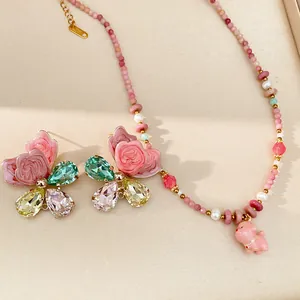 Close-up of pink ceramic beaded necklace with dog pendant and butterfly earrings