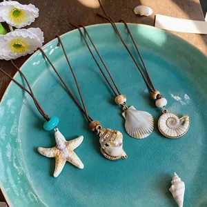 Set of bohemian beach shell necklaces with starfish and conch pendants on brown cords