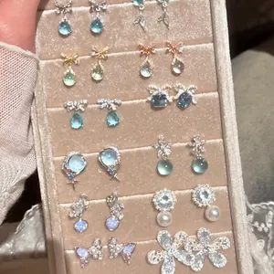 Assorted elegant jewelry tray featuring bow, butterfly and heart earrings collection