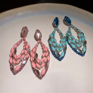 Detailed view of elegant Bohemian jeweled hollow teardrop earrings in pink and blue shades.