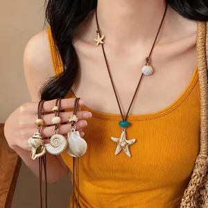 Close-up of Bohemian starfish and shell pendants on adjustable brown cords.