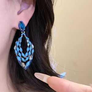 Close-up of bohemian blue drop earrings with marquise beads and crystals